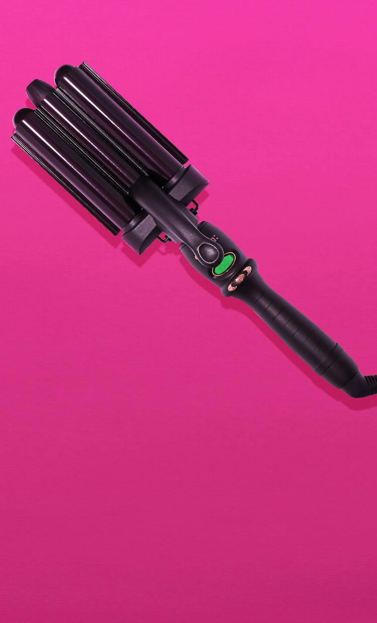 amika high tide deep waver curling iron on a pink background