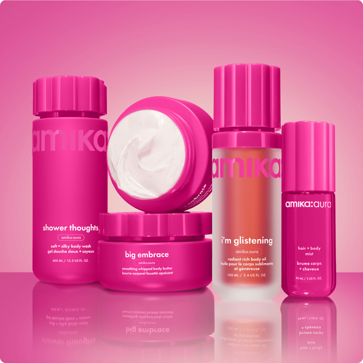 amika shower thoughts body wash, i'm glistening body oil, big embrace body butter, and amika:aura hair and body mist sit against a pink gradient background