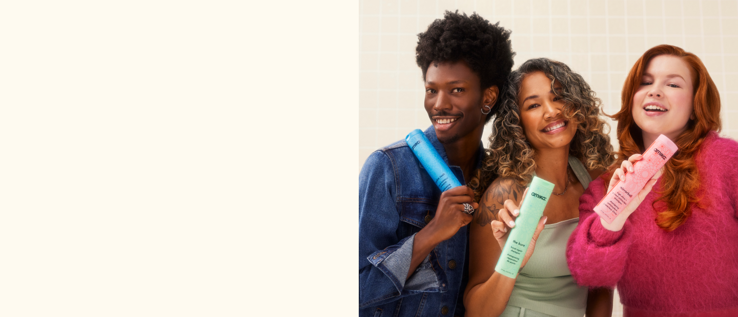 models posing with amika shampoo and conditioners on a white tile background