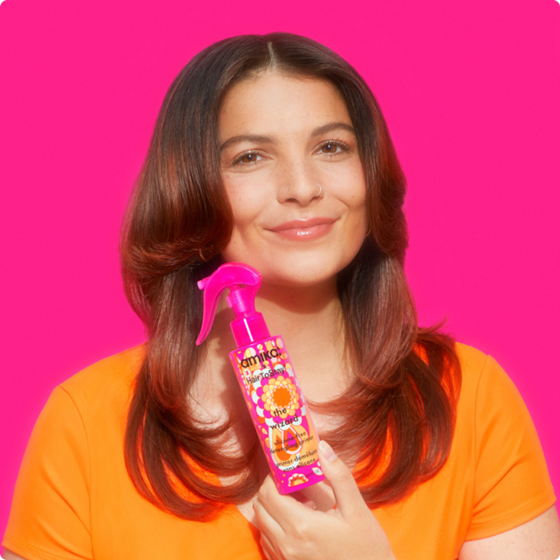 model holding amika x HairToStay the wizard silicone-free detangling primer