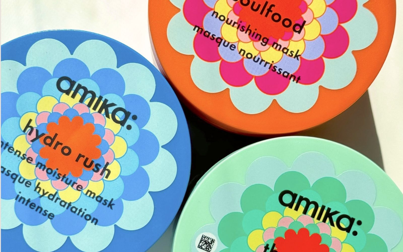 amika mask jars (top view): soulfood, the kure, and hydro rush against a cream background