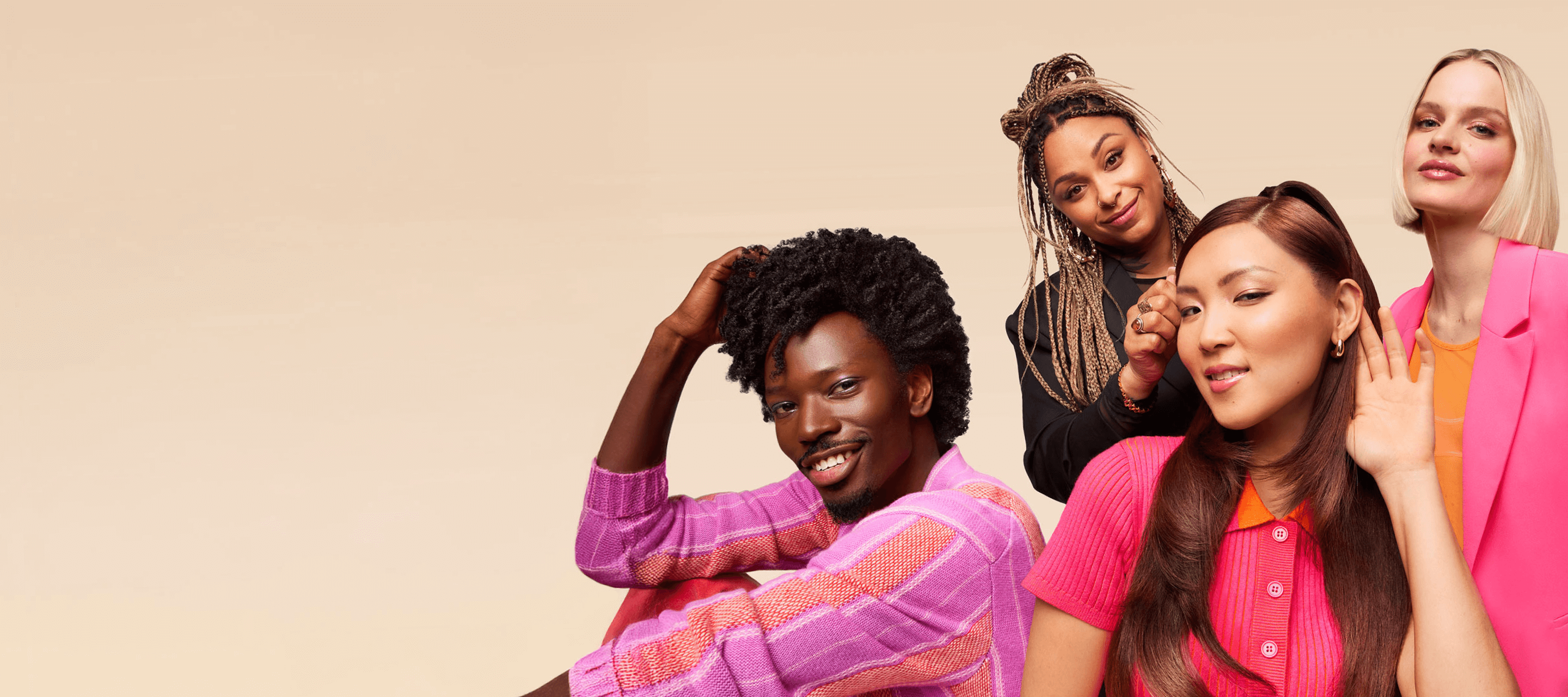 4 models pose against a cream background. the foremost model holds their hand to their ear to indicate that they're listening
