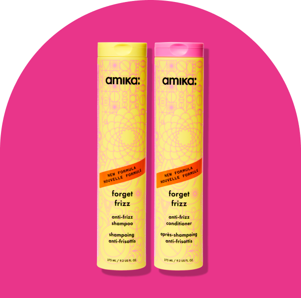 Image of the forget frizz shampoo and conditioner against a hot pink background.