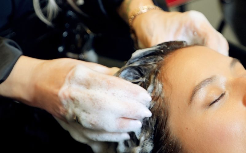 a hairstylist shampooing a client's hair