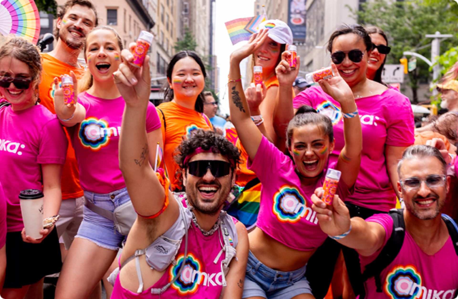 amika employees holding perk up samples at Pride celebration