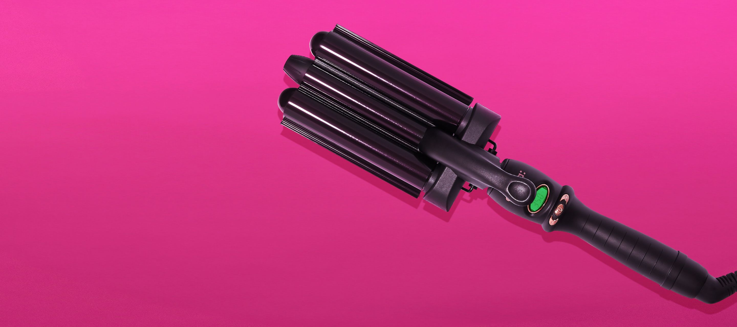 amika high tide deep waver curling iron on a pink background