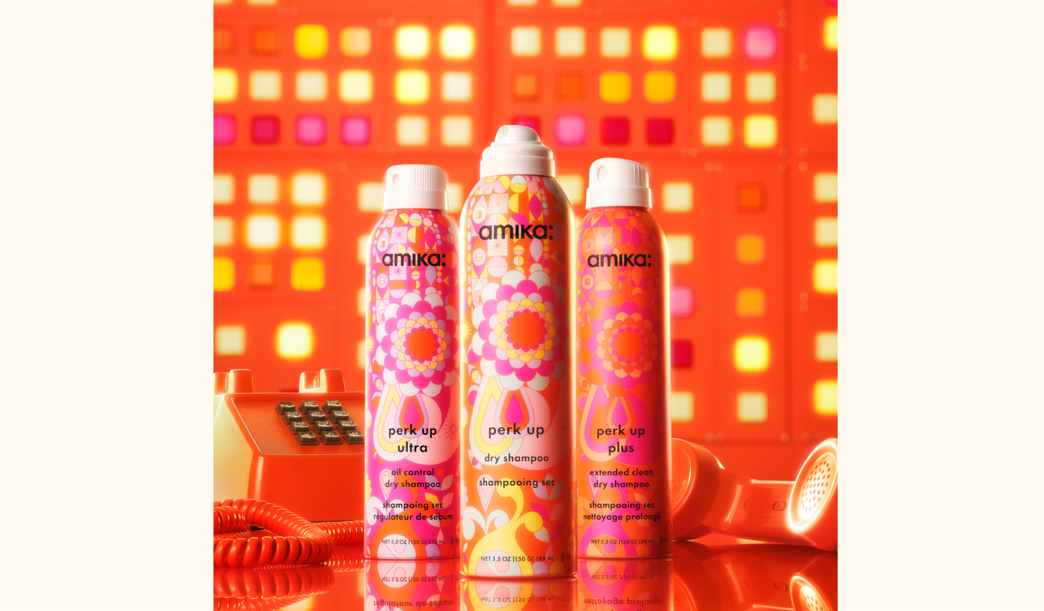 the perk up collection of dry shampoos in front of orange phone and orange background