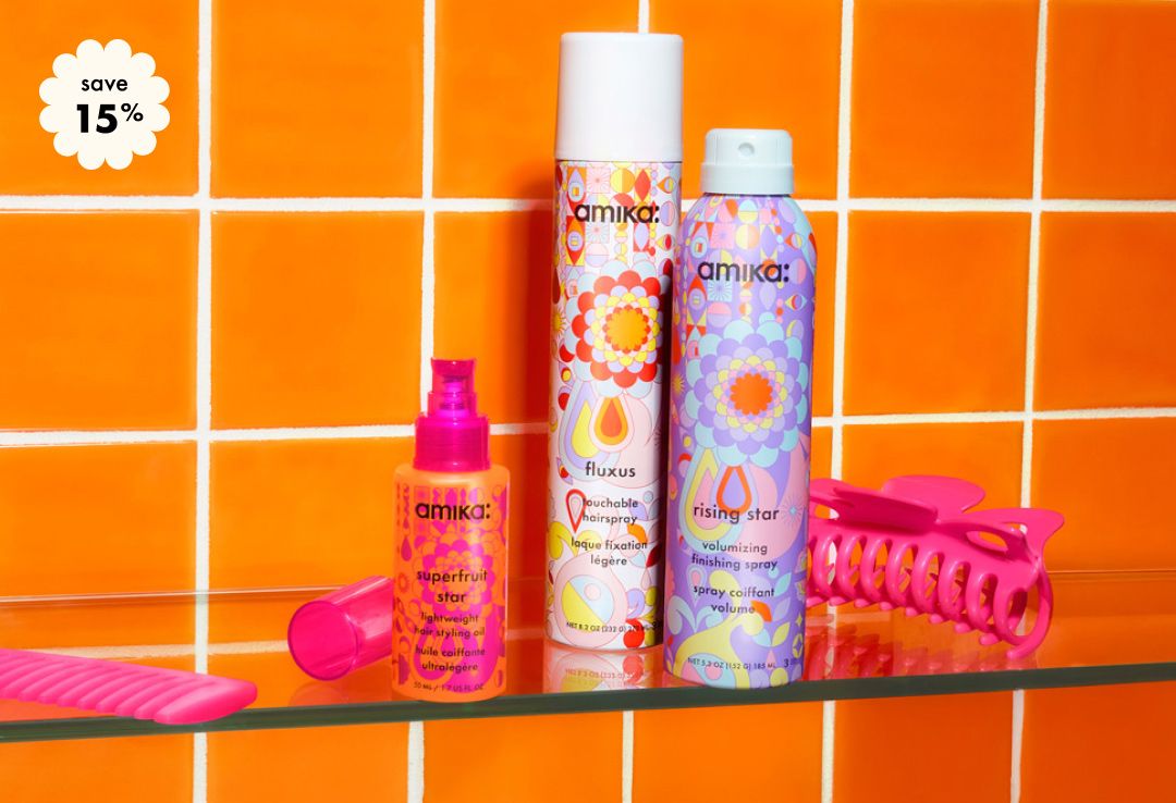 save 15% on your custom amika styling bundle - 3 bottles of amika products and a pink clip sit on a shelf in frount of an orange tiled background