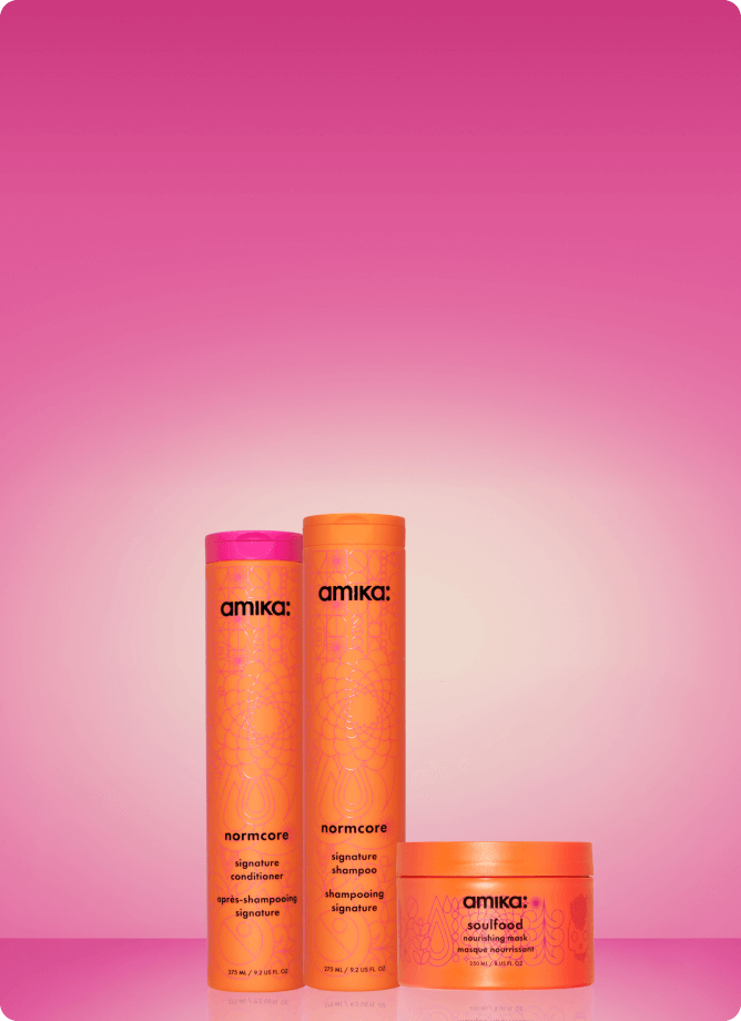 amika normcore shampoo and conditioner and soulfood mask sit against a pink gradient background