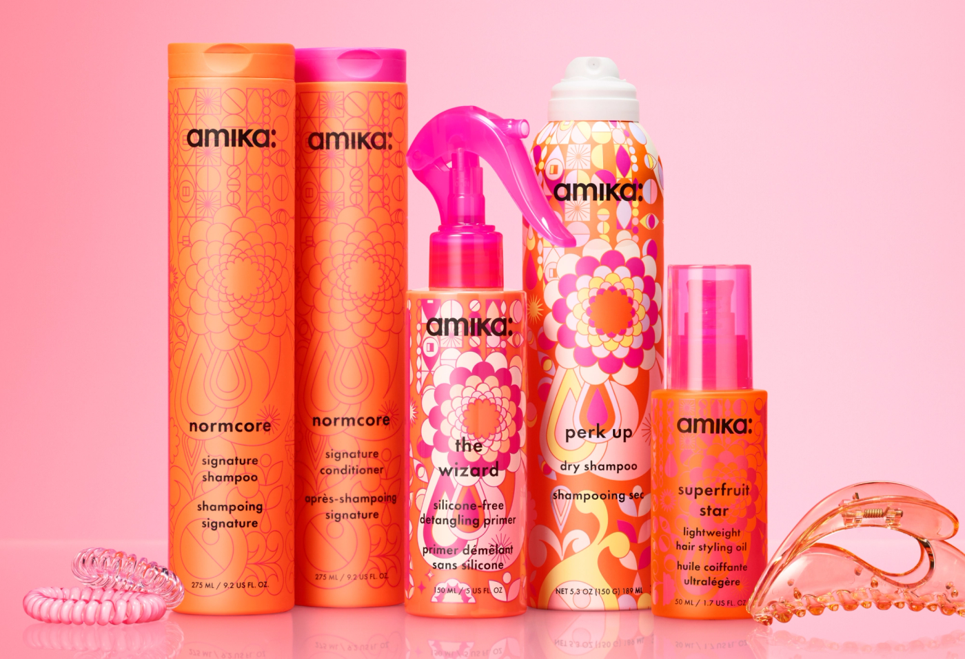 amika products on a pink shelf with pink background