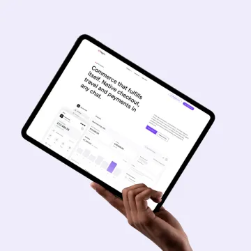 A hand holding a tablet showing the commerce page — Commerce that fulfils itself.