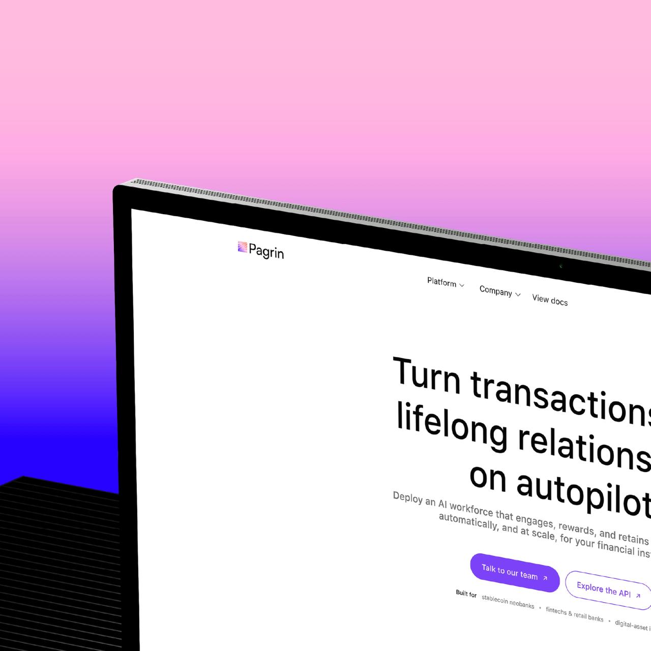 The Pagrin marketing site on a monitor, angled against a pink-to-purple gradient.