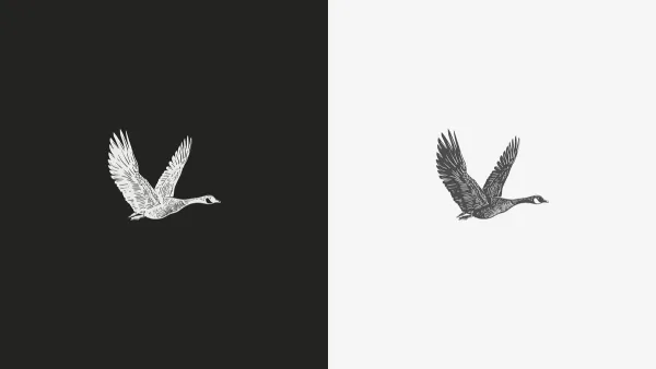 The engraved goose mark shown twice, light on charcoal and dark on pearl