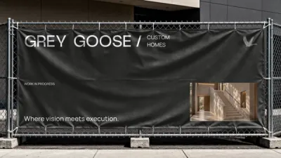 A black Grey Goose Custom Homes banner on a construction fence, reading Work in progress and Where vision meets execution