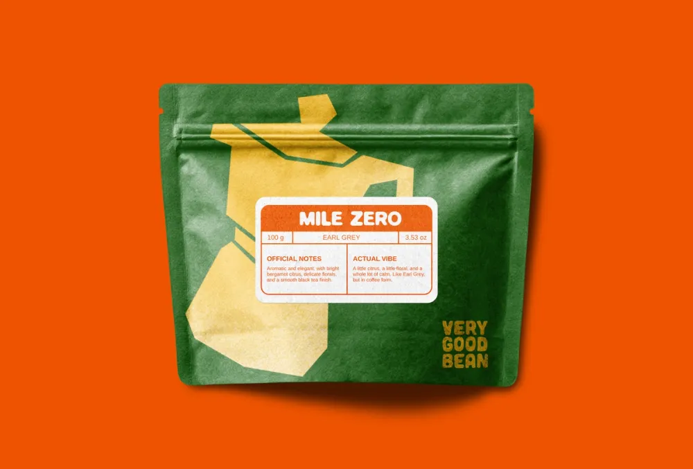 A green Mile Zero bag on orange, with a yellow cut-paper moka pot and a label listing official notes and actual vibe