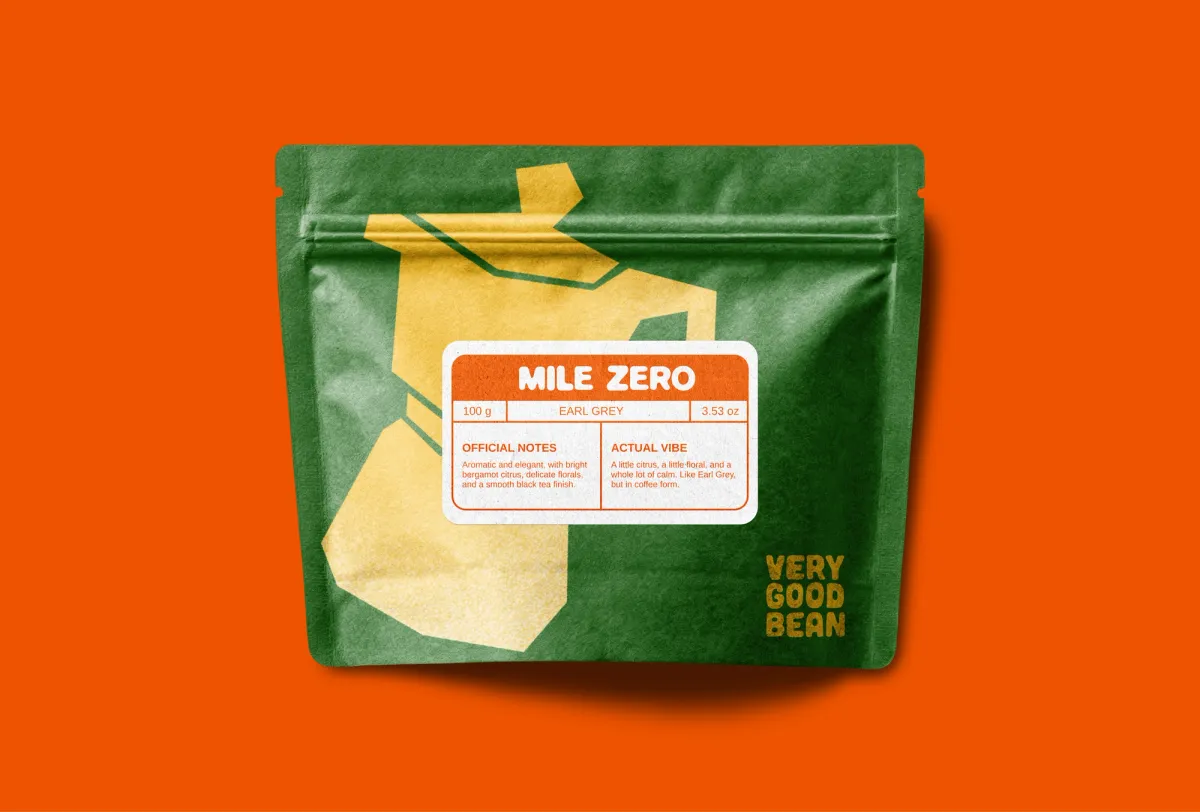 A green Mile Zero bag on orange, with a yellow cut-paper moka pot and a label listing official notes and actual vibe