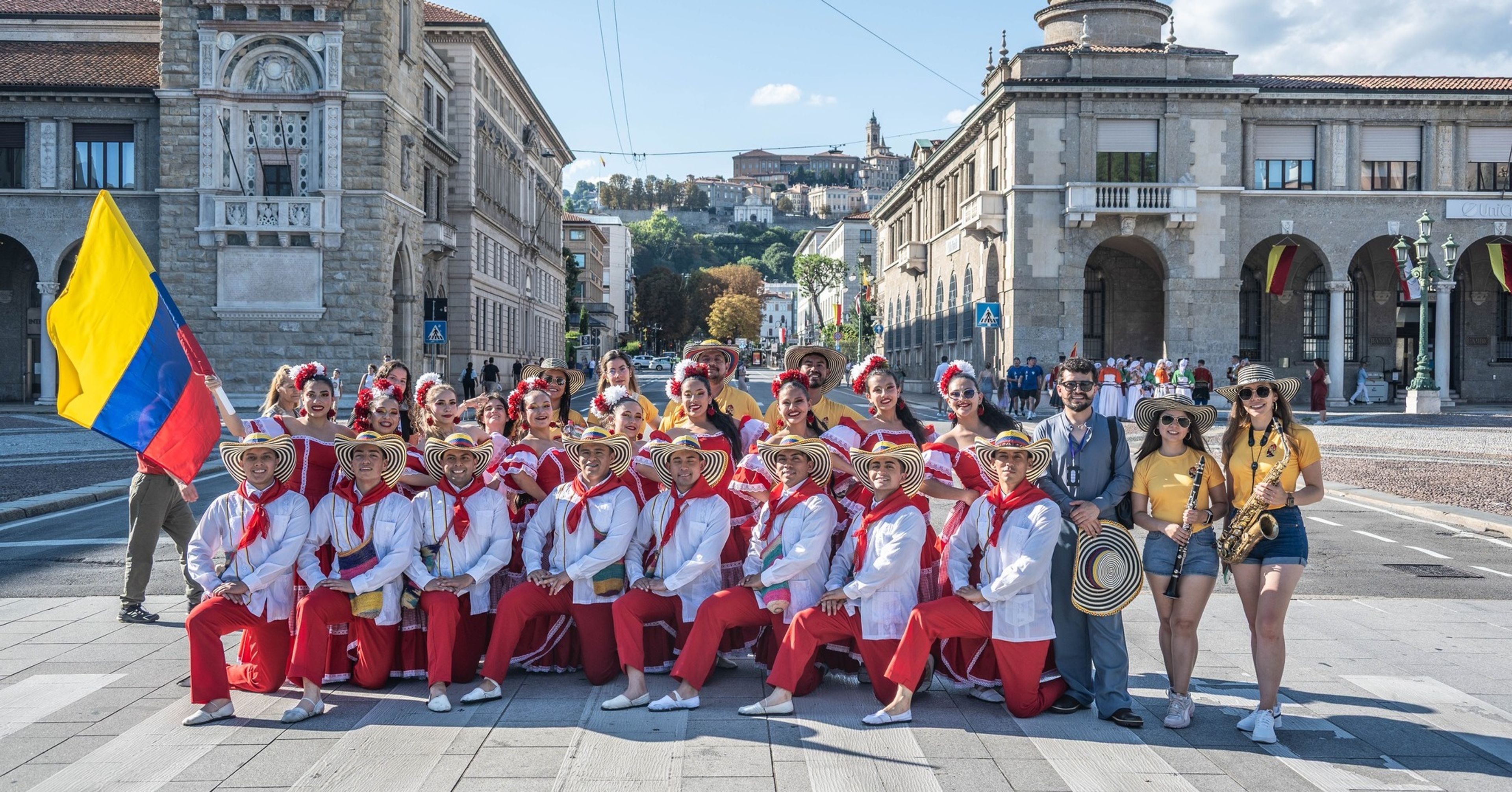 Folk performance with musicians and dancers in traditional European costumes during Europeade in Bergamo, organized by Ducato di Piazza Pontida.