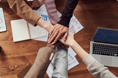 Hands piled together in collaboration