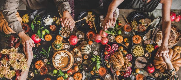 hands held over thanksgiving meal