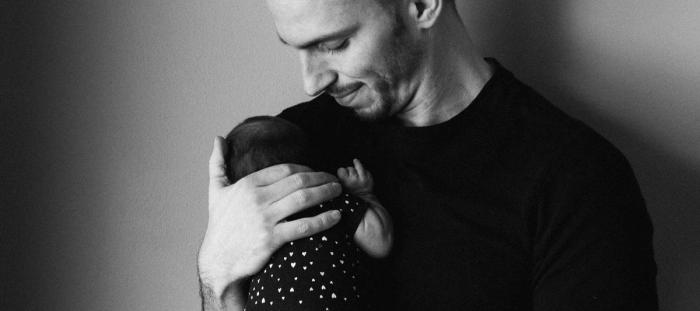 man carrying baby