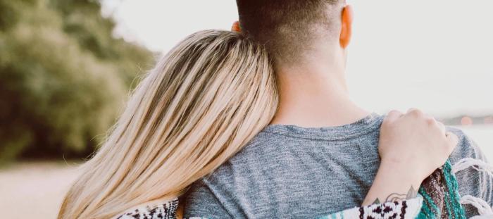 woman's hand on man's shoulder