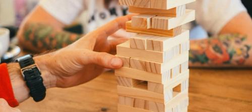 Two people playing a game of jenga.