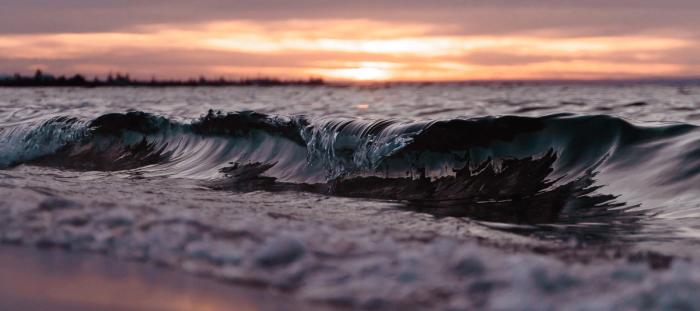 waves on the beach at sunset