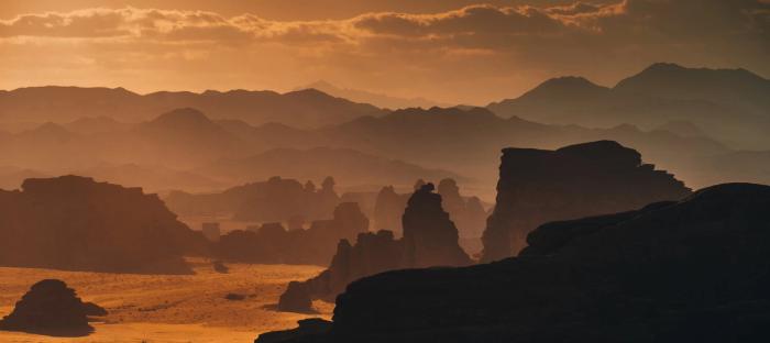 Beach scene with caves in the sunset