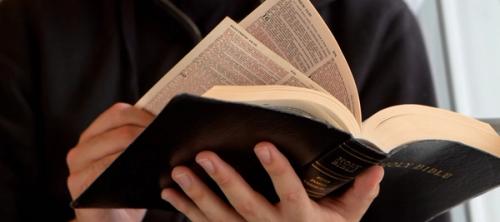 An open Bible showing the first page of Matthew's Gospel.