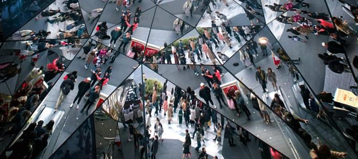 people reflected in a hall of mirrors
