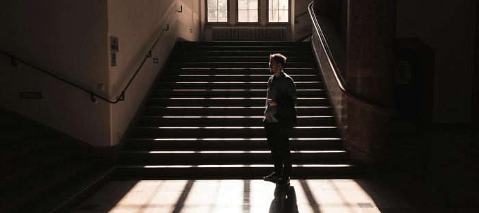 a person standing on a set of stairs in a building