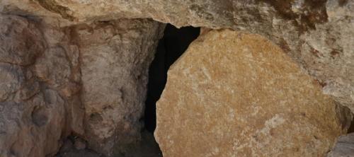 A cave with a stone door