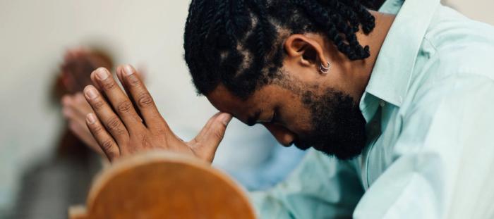 A man bowed in prayer
