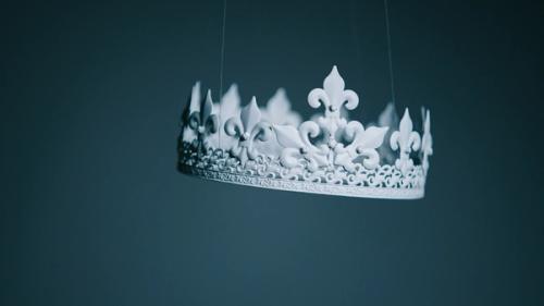 CC-  A white crown with a fleur-de-lis design floats midair on a dark background. 
