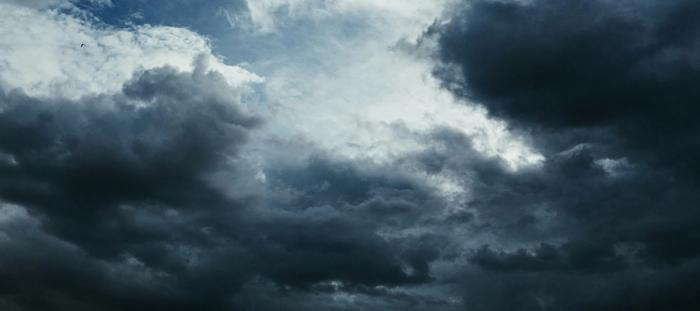 A stormy sky, with an opening of blue in the center
