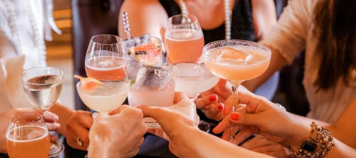 A group of people toasting with drinks