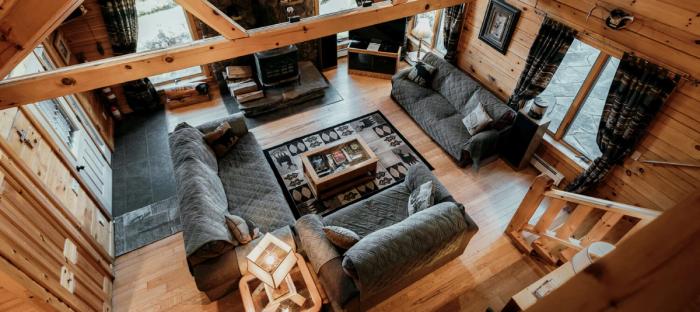 Living room photo in a cabin with couches and fireplace