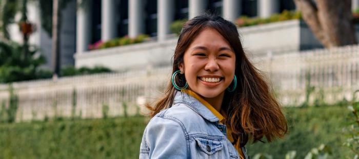 woman in blue denim jacket smiling