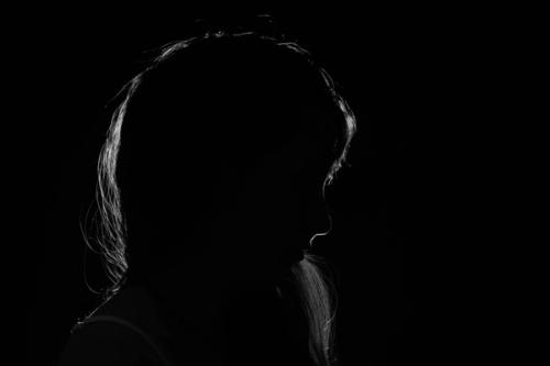 CC- a dark silhouette of a woman's profile.