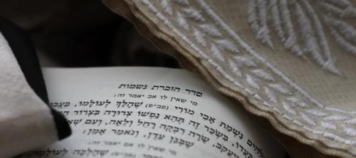 Page of Torah under beige linen with white intricate detail