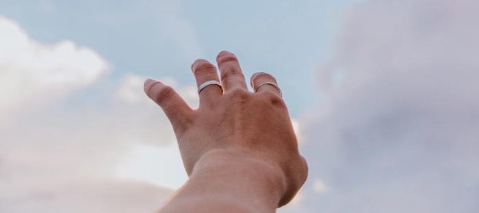 hand reaching up to clouds 