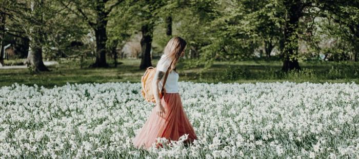 woman walking on flower field