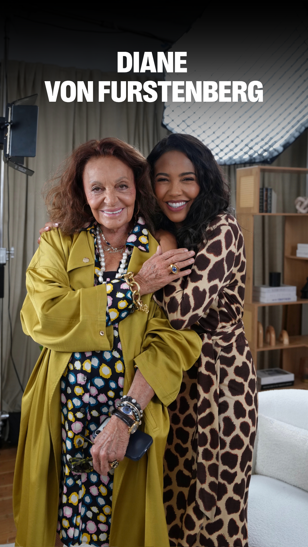 Diane Von Furstenberg and a smiling younger woman embrace, with her name text at the top.