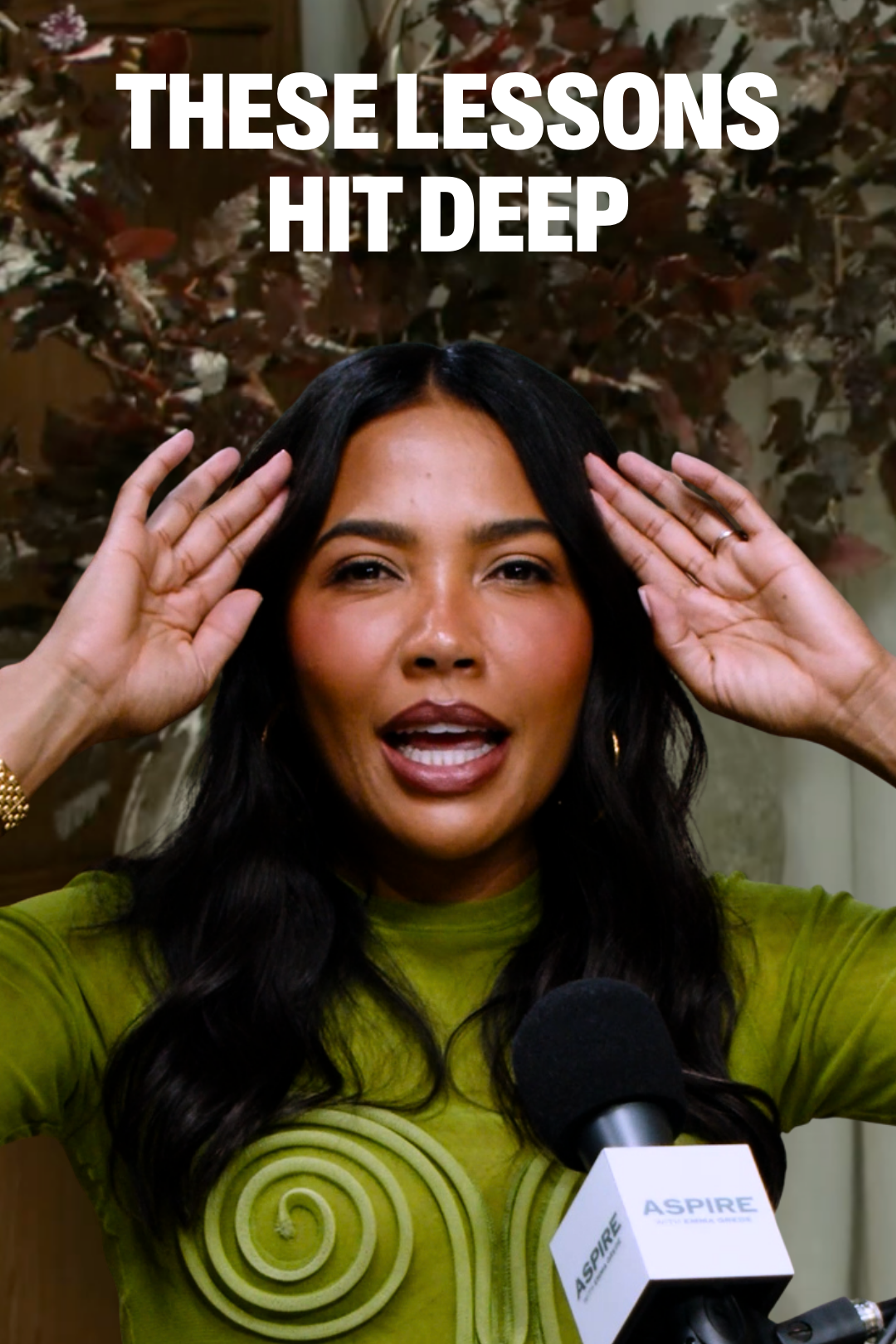 A woman emma grede, wearing a lime green top with a spiral design, gestures with her hands while speaking into an Aspire microphone. White text above reads "THESE LESSONS HIT DEEP".