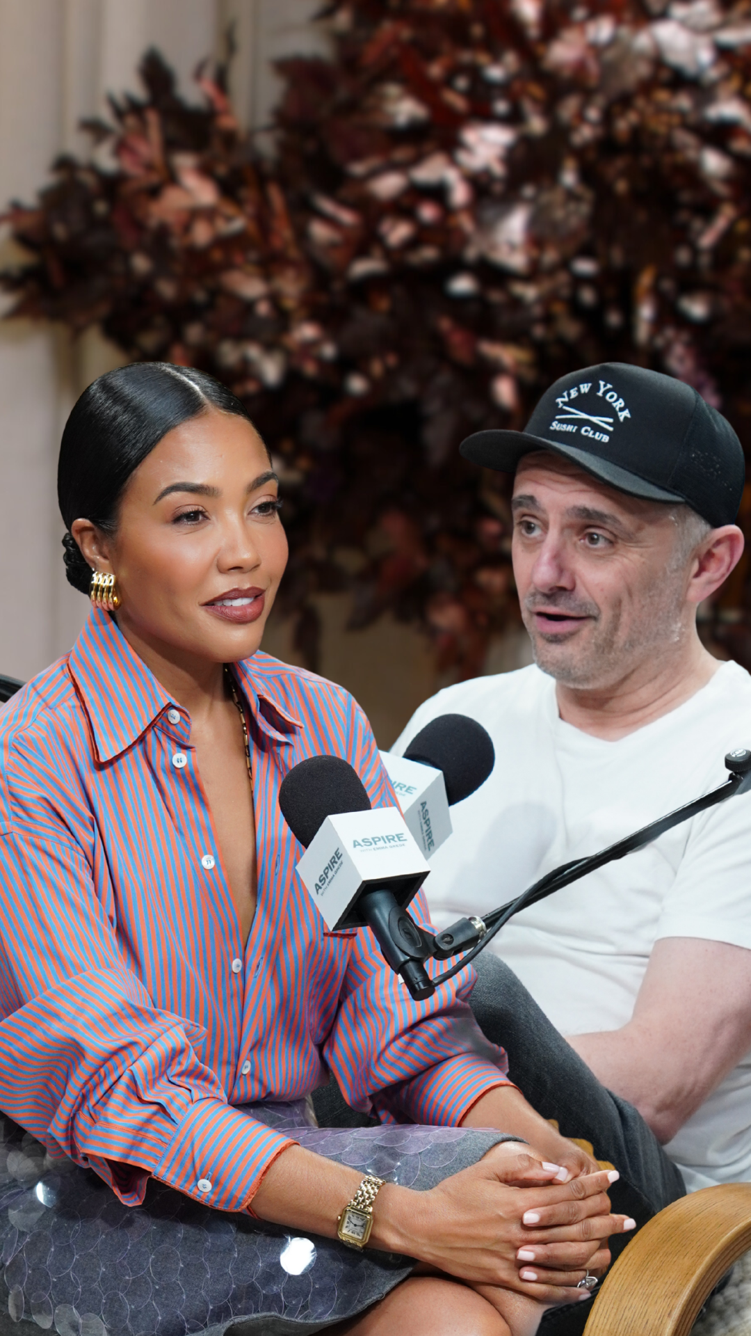 A woman in a striped shirt and a man in a baseball cap speak into ASPIRE microphones.