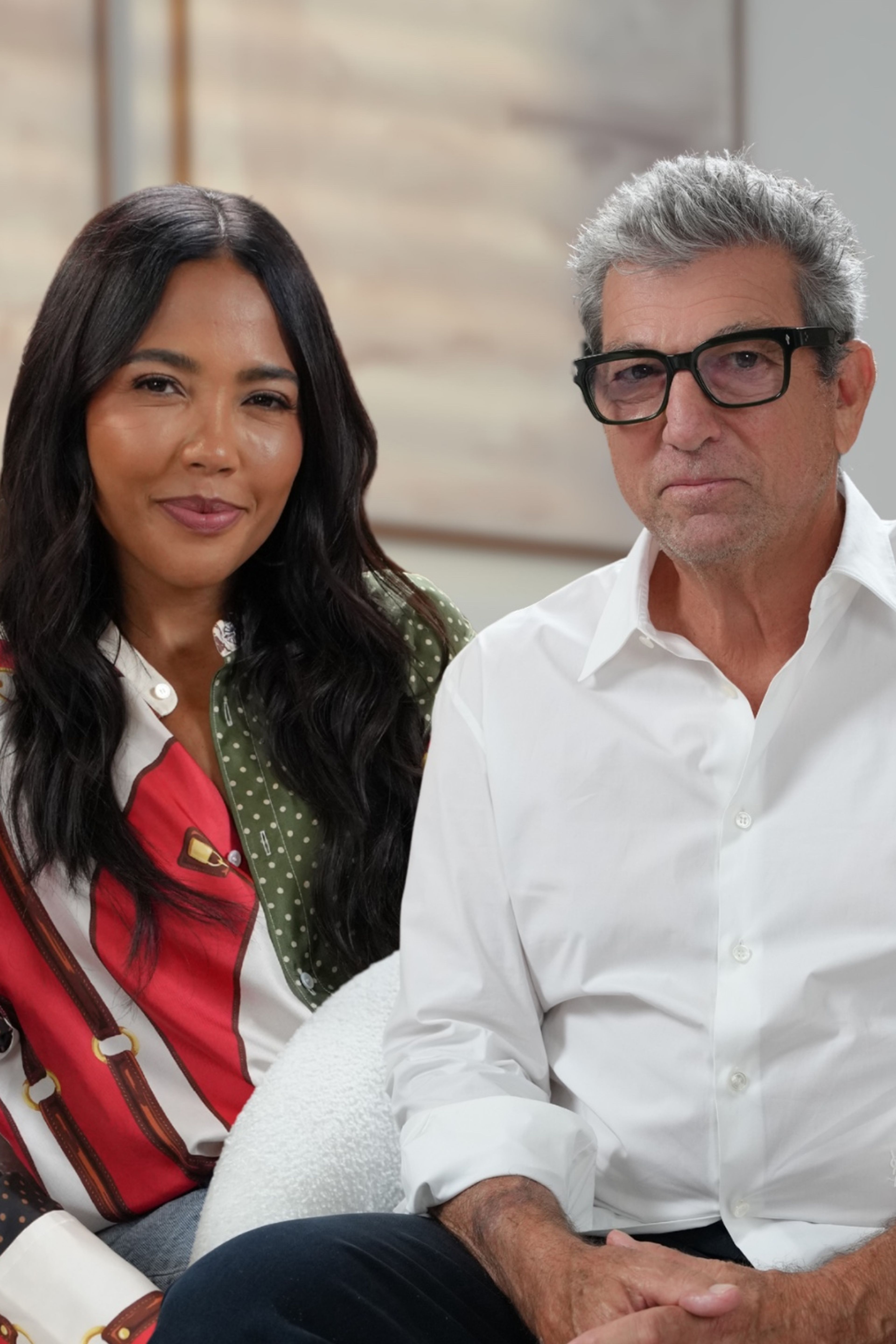 A smiling woman and a serious man in glasses sit under the text "HOW GREAT BRANDS ARE BUILT w/ Andrew Rosen".