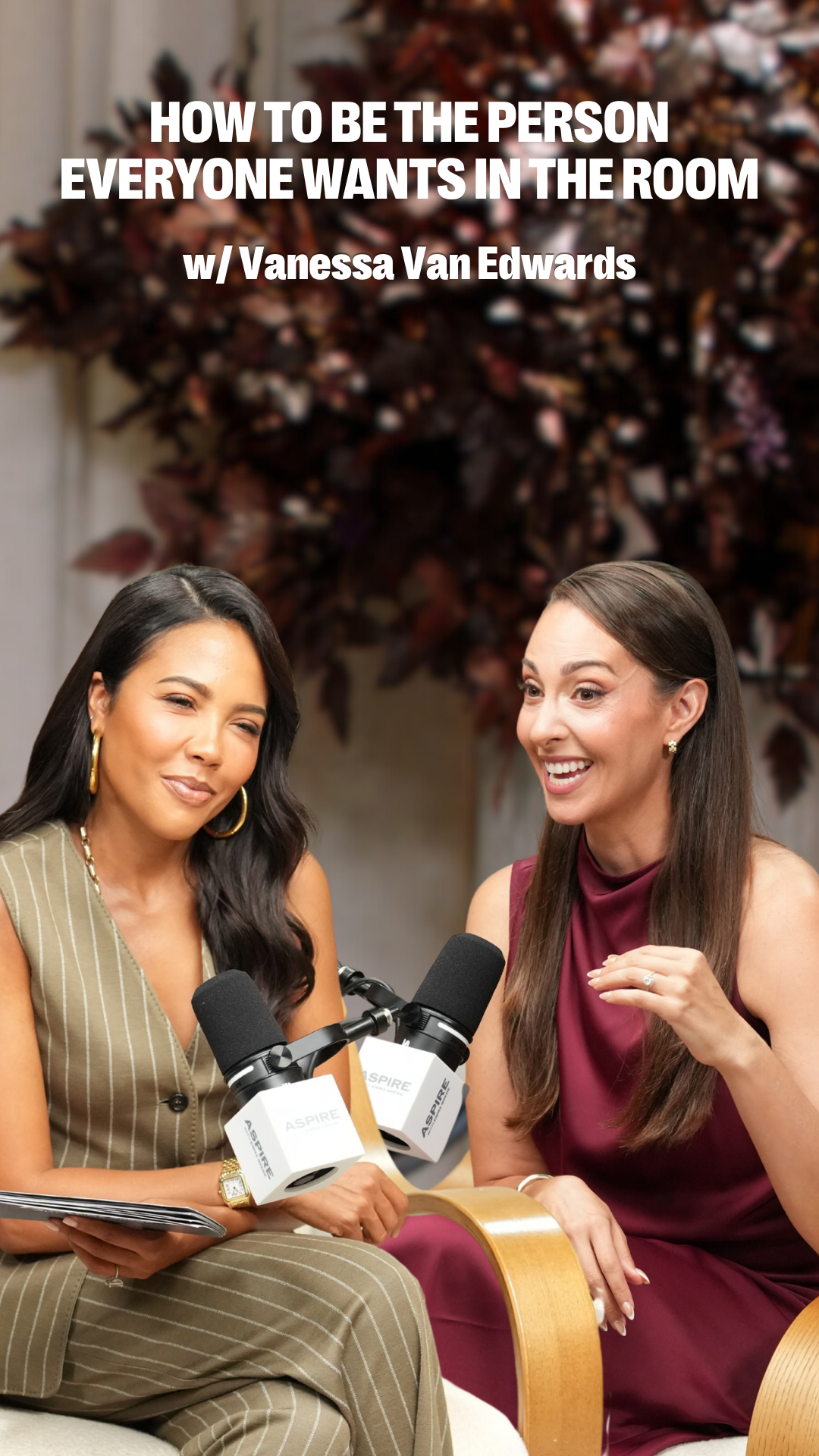 Two smiling women, one holding a tablet and the other gesturing, sit with microphones in front of a blurry background. Text overlay reads: "HOW TO BE THE PERSON EVERYONE WANTS IN THE ROOM w/ Vanessa Van Edwards".