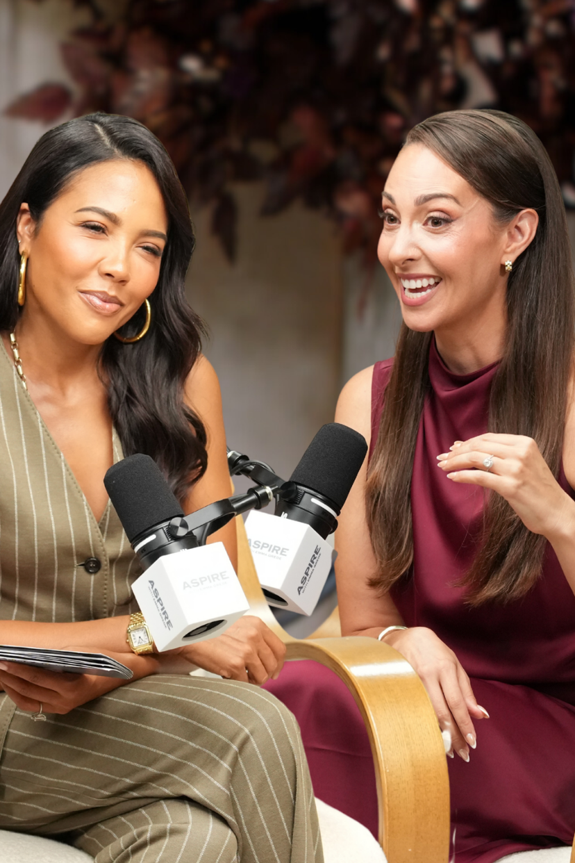 Two smiling women, one holding a tablet and the other gesturing, sit with microphones in front of a blurry background. Text overlay reads: "HOW TO BE THE PERSON EVERYONE WANTS IN THE ROOM w/ Vanessa Van Edwards".