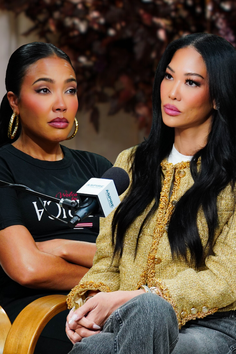 Two women, one in a gold tweed jacket and one in a black t-shirt, sit with a microphone between them during an interview.