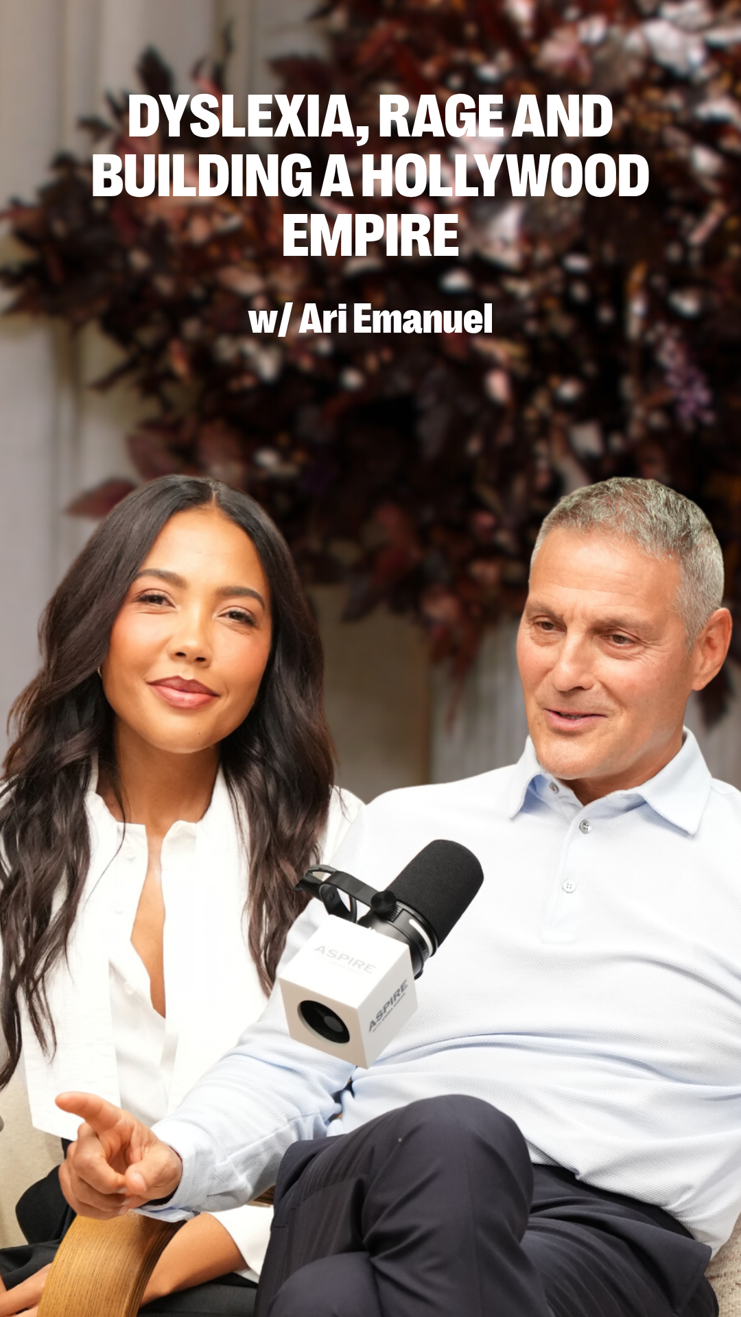 A smiling woman and Ari Emanuel sit in an interview with a microphone. Text overlay reads: DYSLEXIA, RAGE AND BUILDING A HOLLYWOOD EMPIRE w/ Ari Emanuel!